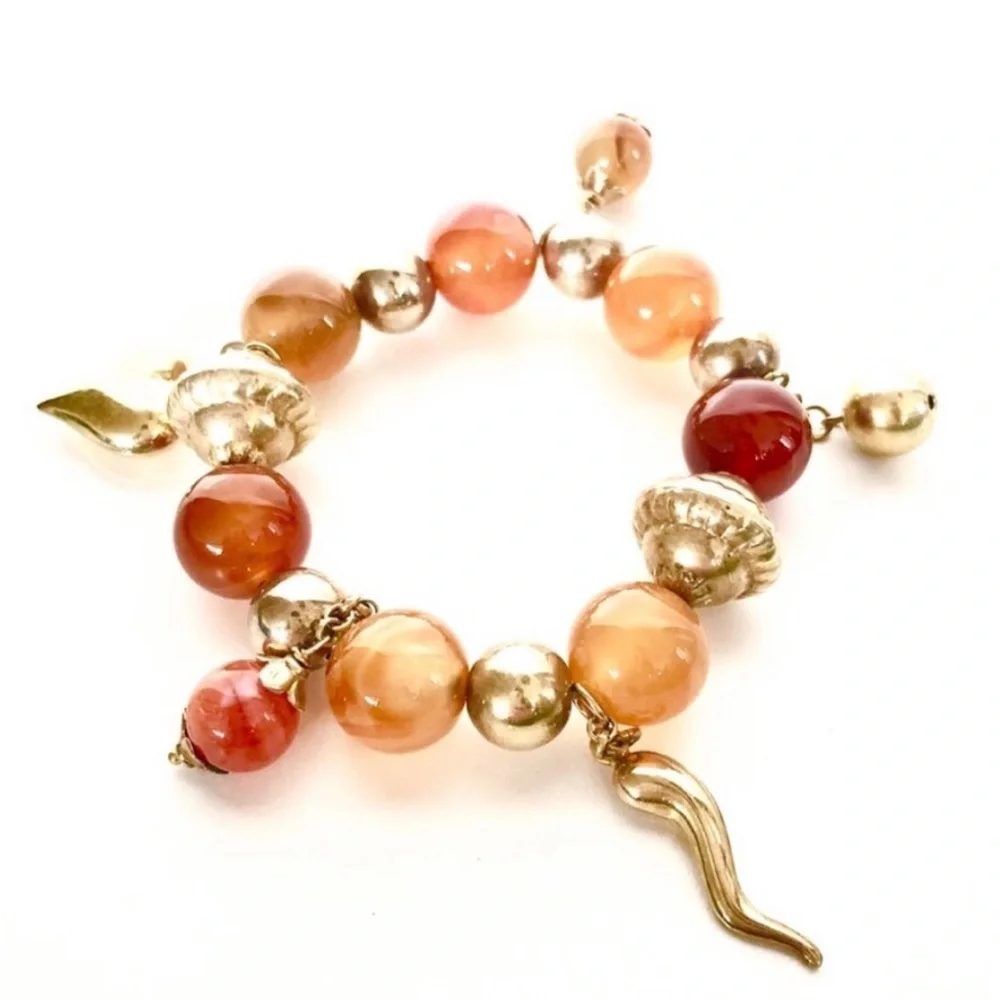Handcrafted artisan amber tone stones paired with gold heart beaded charms brace